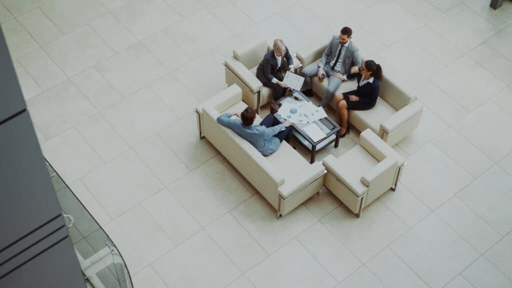 Aerial view of a group business meeting in a modern office setting.