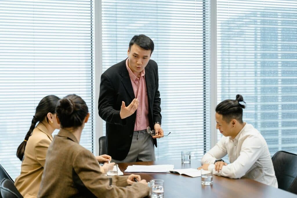 A group of professionals engaged in a business meeting in a modern office setting.